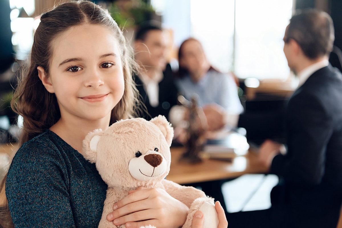 Happy,Little,Girl,Is,Hugging,Teddy,Bear,At,Office,Of